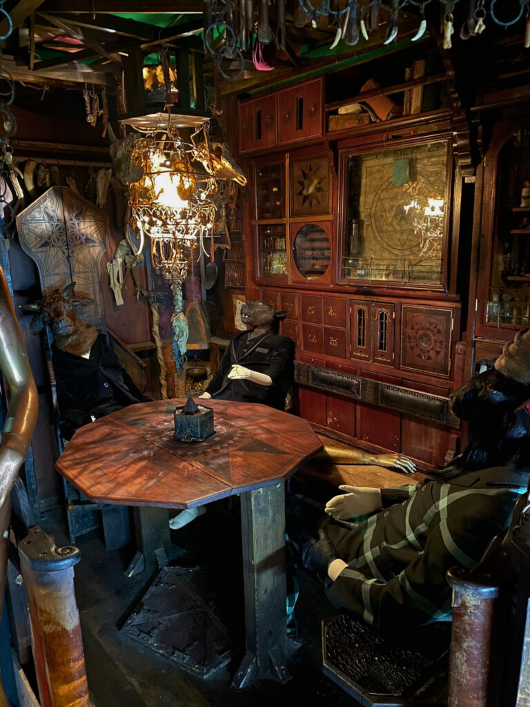 Taxidermy sitting at the Devil's Table at the Viktor Wynd Museum